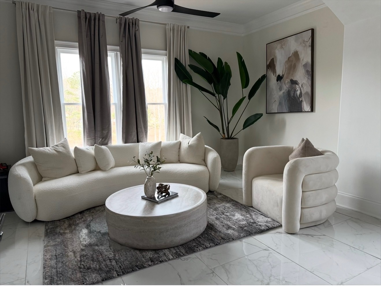 Modern luxury living room — curved boucle sofa and marble floors