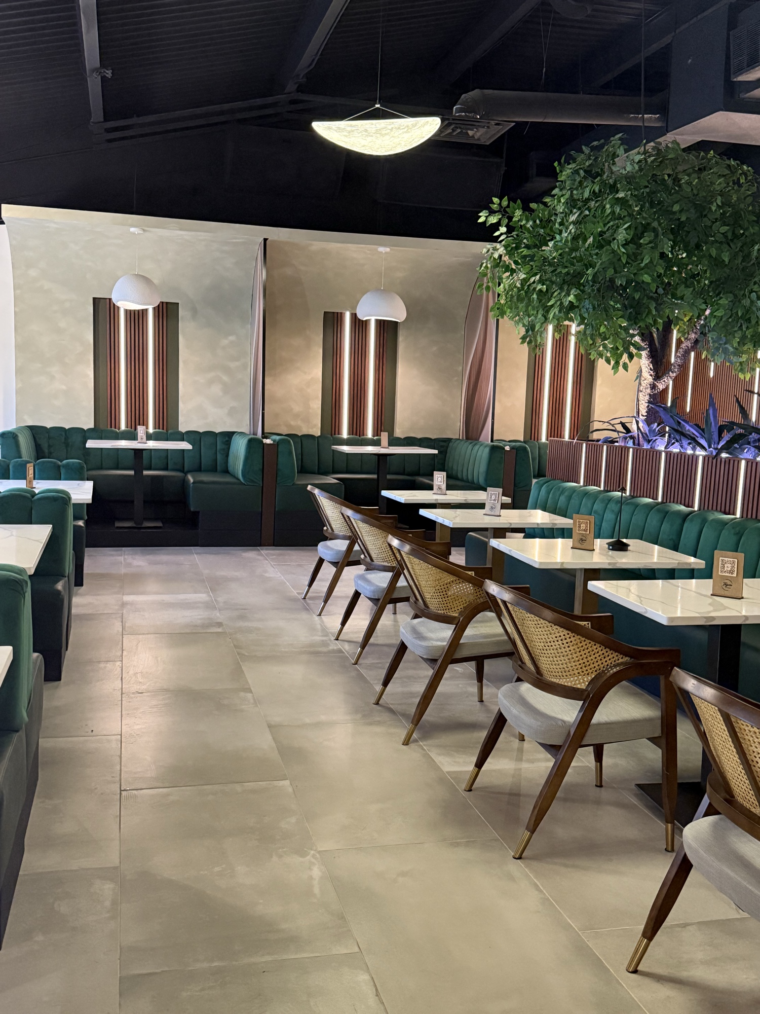 Thyme Restaurant dining room with emerald velvet banquettes