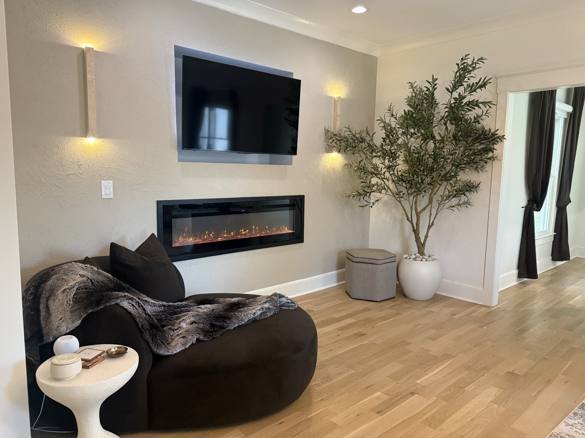 Warm living room with fireplace and olive tree