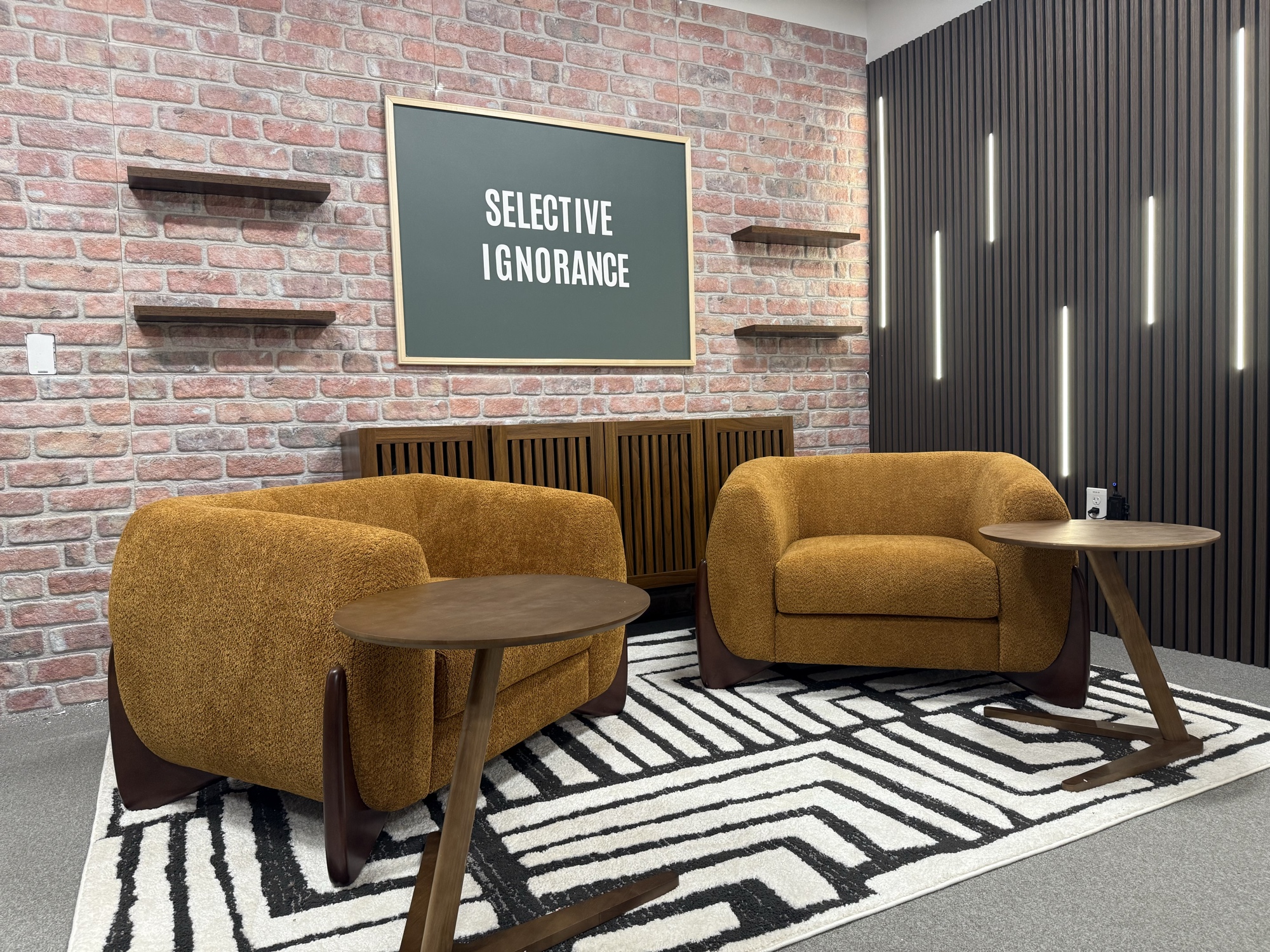 Commercial lounge with amber boucle chairs and exposed brick
