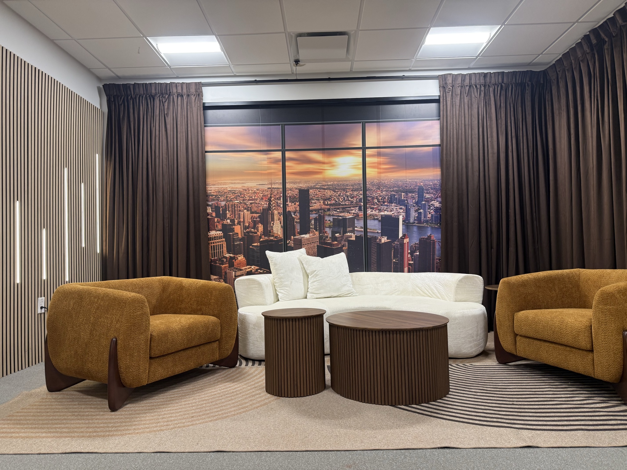 Office lounge with amber chairs and Manhattan skyline mural