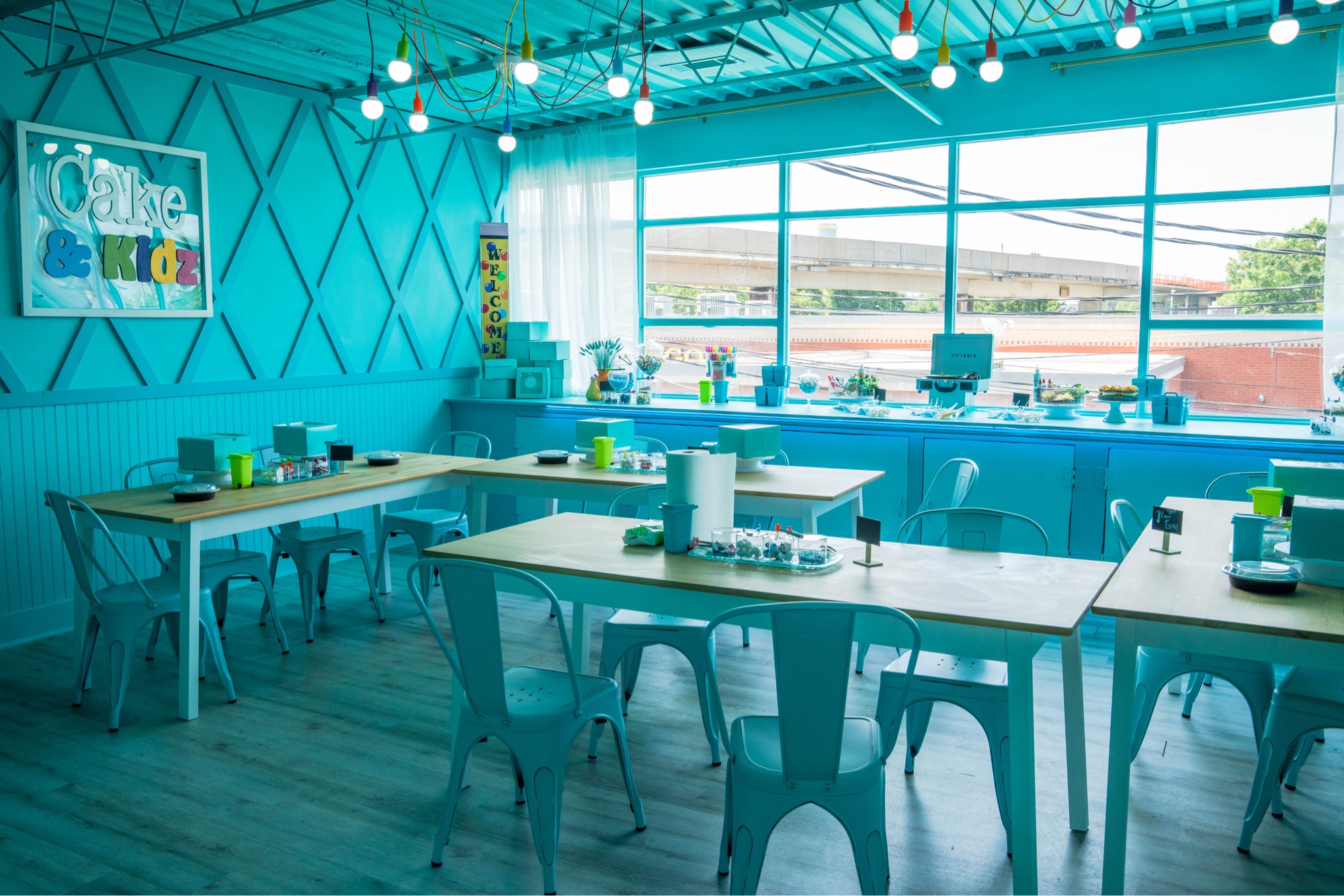 Cake & Kidz — full teal commercial interior with pendant lighting