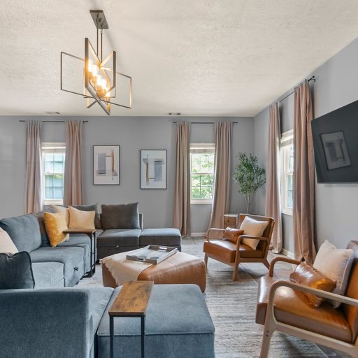 Modern living room with gray sectional and leather accent chairs