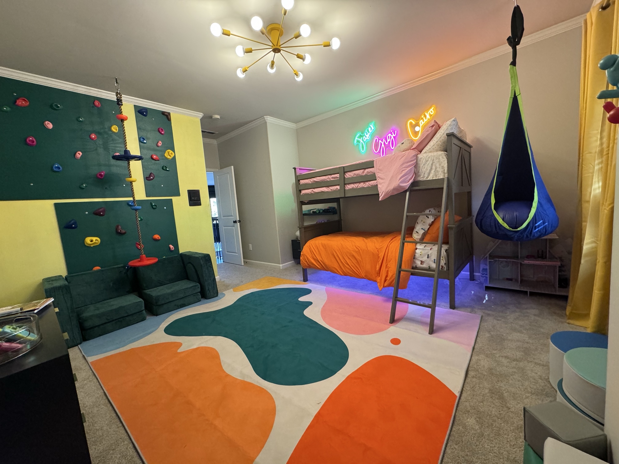 Kids neon bedroom with climbing wall, bunk bed and custom rug